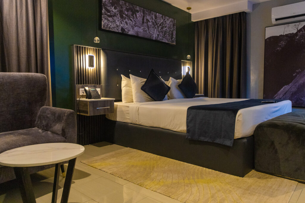 Accommodation Types 4 executive suite ikogosi resort bed side view